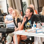 Craig Revel Horwood and creatives watching at table and keyboard