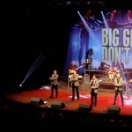 Big Girls Don't Cry stage, performers with guitars and microphones