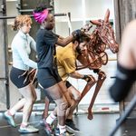 Eloise Beaumont-Wood, Diany Samba-Bandza, Jordan Paris operate a life-size brown foal, running in the rehearsal studio