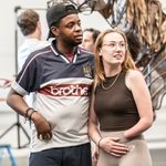 Ike Bennett and Lucy Thorburn stand closely in the rehearsal studio