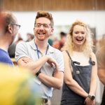 Matthew Forbes (Puppet-Director) laughs with the cast in rehearsal studios