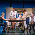 Heidi (Alice Fearns), Larry (Richard Hurst), Zoe (Lauren Conroy), Cynthia (Helen Anker), and Evan (Ryan Kopel) at the kitchen table, wine being poured.