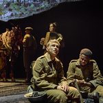 David Taylor (Ike Bennett) sits with an upwards looking Albert Narracott (Tom Sturgess) in trench greens with horse Joey out of focus behind them