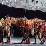 Albert Narracott (Tom Sturgess) cradles horse Joey's (puppeteers Matthew Lawrence, Rafe Young, Felicity Donnelly) head