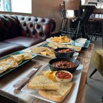 A table full of different plates of food.