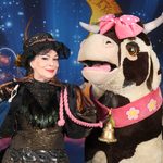 Mrs Blunderbore (Anne Smith) holding Daisy the pantomime cow's pink lead