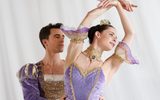 Sugar Plum Cavalier (Aitor Arieta) supports Sugar Plum Fairy (Emma Hawes) as she leans, arms raised, both wearing lilac and white