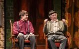 Rodney (Tom Major) and Grandad (Paul Whitehouse) sit in arm chairs