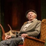 Grandad (Paul Whitehouse) sitting in an armchair, side view