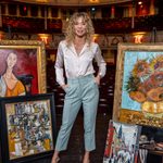 Jodie Steele in theatre surrounded by paintings