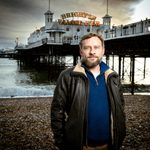 Peter Ash on beach in front of Brighton Palace Pier