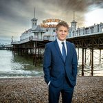 George Rainsford on beach in front of Brighton Palace Pier