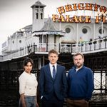 Fiona Wade, George Rainsford and Peter Ash standing on beach in front of Brighton Palace Pier