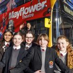 Mayflower Transport Subsidy Scheme Five teenagers in school uniform standing in front of a Mayflower bus branded with characters from shows