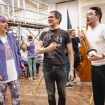 Peter Peverley (Henry Miller) points at a trumpet holding Isaac Savage (Francis Fryer) as Hollie Cassar (Susan) looks on shocked