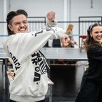 Liam McEvoy & Cerys Burton wheel their hands in the air as they dance, smiling