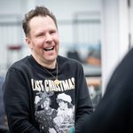 Nikolai Foster (Director) laughs wearing last christmas jumper