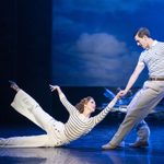 Julian Craster (Dominic North) drags Victoria Page (Ashley Shaw) along the ground, both wearing white and blue striped tops and pale trousers