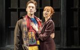 Charlie (Dan Partridge) in Northampton Town FC scarf, with Nicola (Kara Lily Hayworth) clinging to him, hand on chest displaying her engagement ring