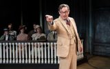 Atticus Finch in beige suit pointing finger as Jury watch from behind