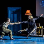 Man and woman dancing at a house.