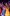 home-stage-performance-aspect-ratio-10-16 A colourful ensemble of performers sing with arms raised.