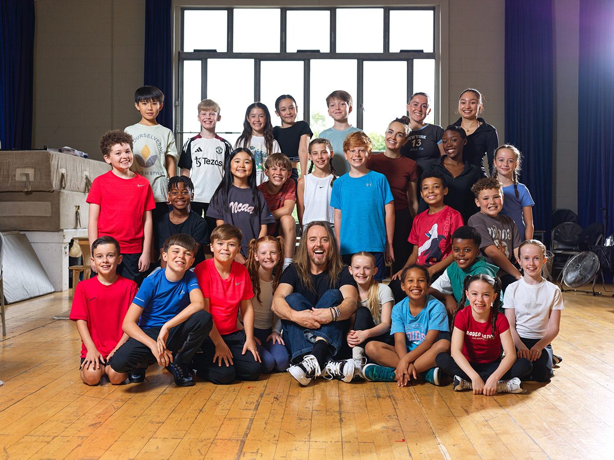Tim Minchin with the cast of Matilda the Musical Tim Minchin sits surrounded by the cast of Matilda in a rehearsal room