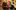 Woman with pink and green hair laughs in conversation with a group of friends