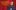 Jack Dee stands in front of a backdrop of red theatre curtains