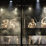 Several male cast members during a musical number set in the lock rooms of the diner